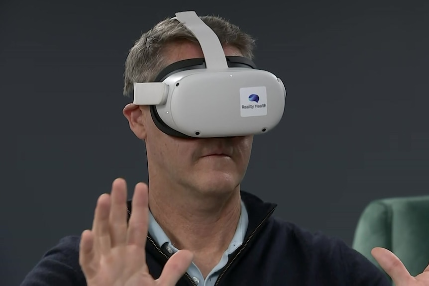 A man wearing virtual reality glasses.