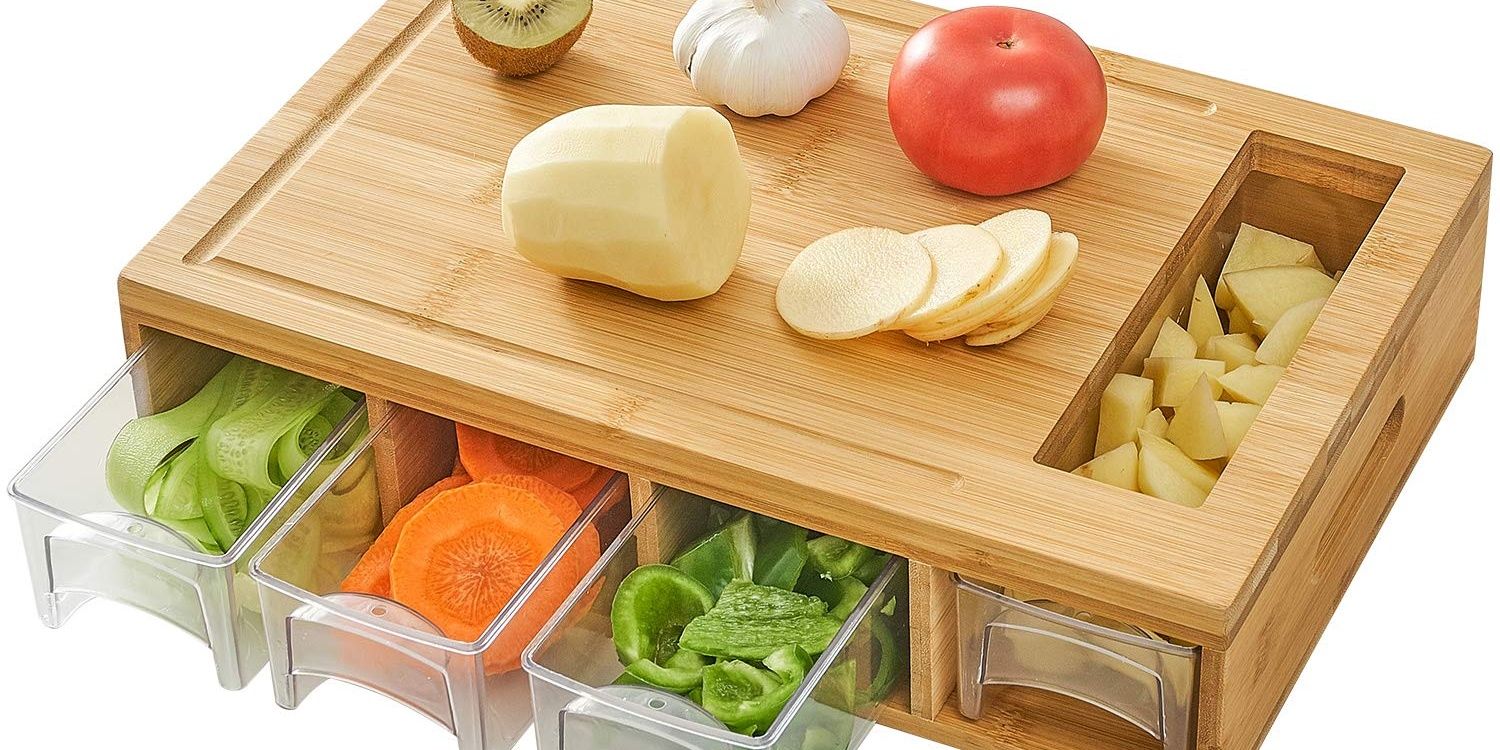 Wooden chopping board with plastic bowls containing chopped vegetables