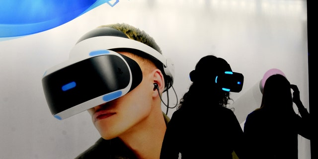 L´HOSPITALET, BARCELONA, SPAIN: A little girl is seen preparing to play with virtual reality glasses on her PlayStation during the Barcelona World Games Fair. 