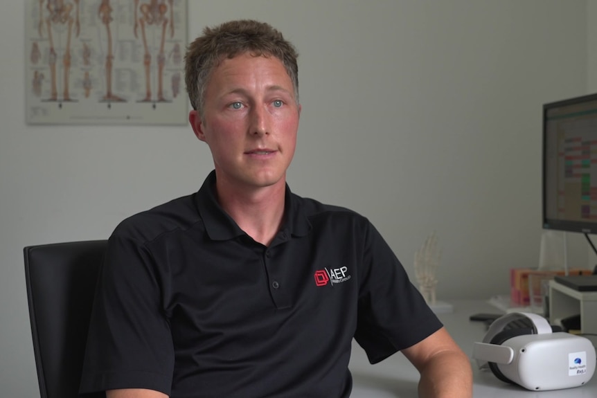 Adelaide physiotherapist Leander Pronk at a desk.